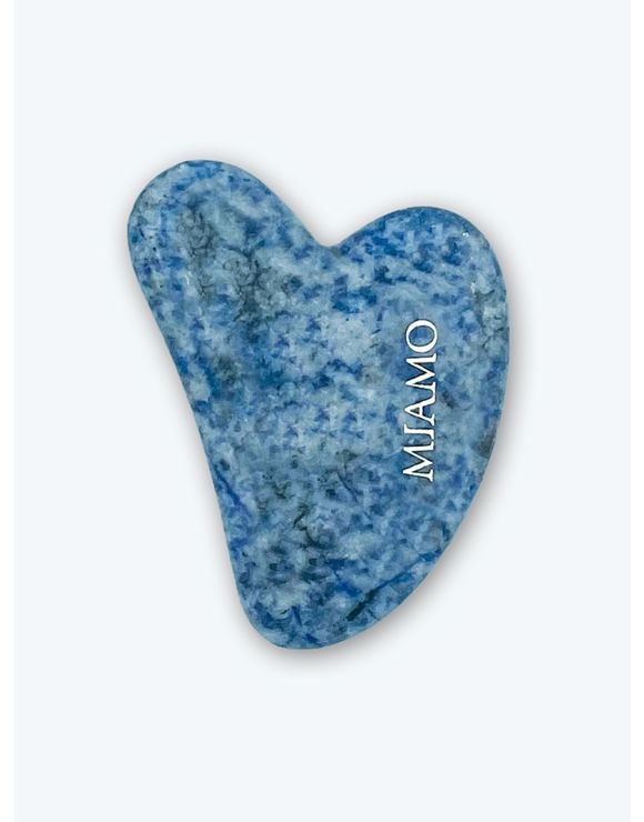 Gua Sha pietra in quarzo a forma di cuore dalla colorazione blu e azzurra su sfondo bianco